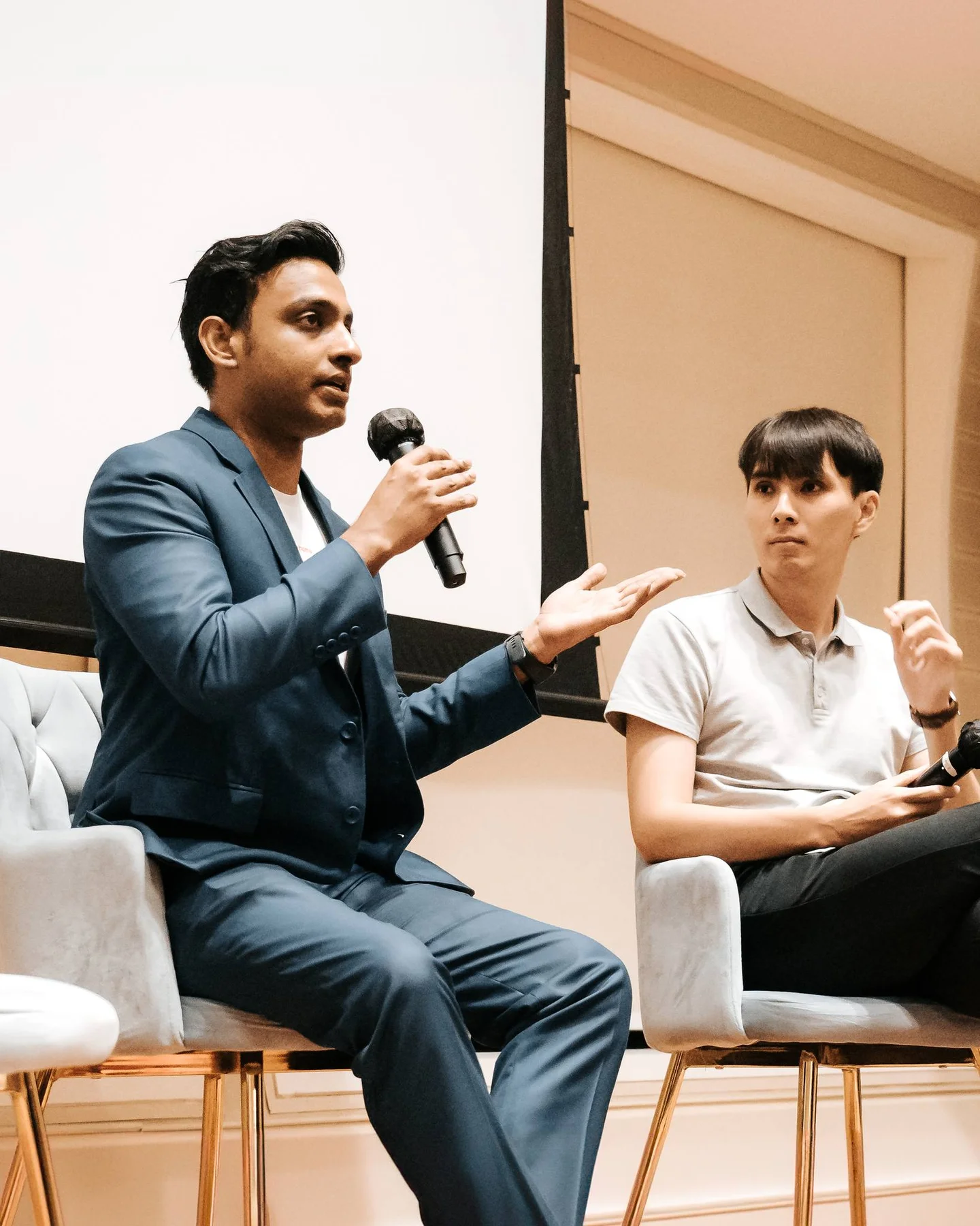 Vairavan speaking with a microphone and gesturing during The Executive Centre panel